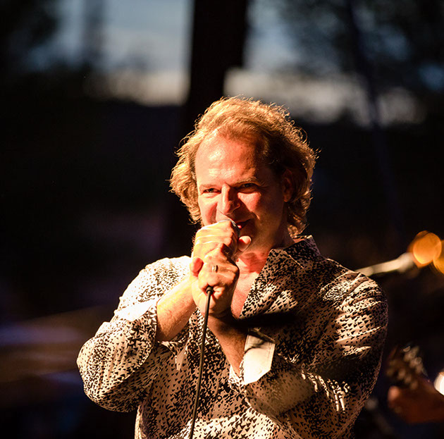 Matt Vee singing in leopard print jacket