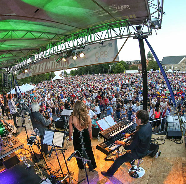 Large outdoor concert stage with crowd